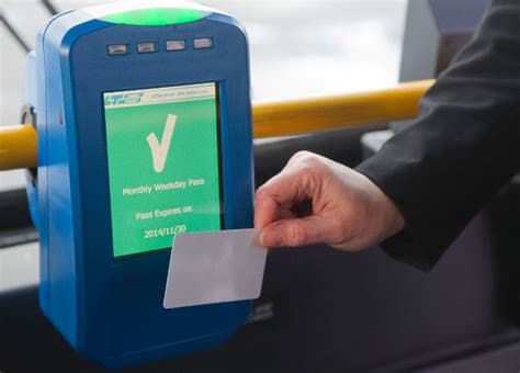 A person scanning a bus pass